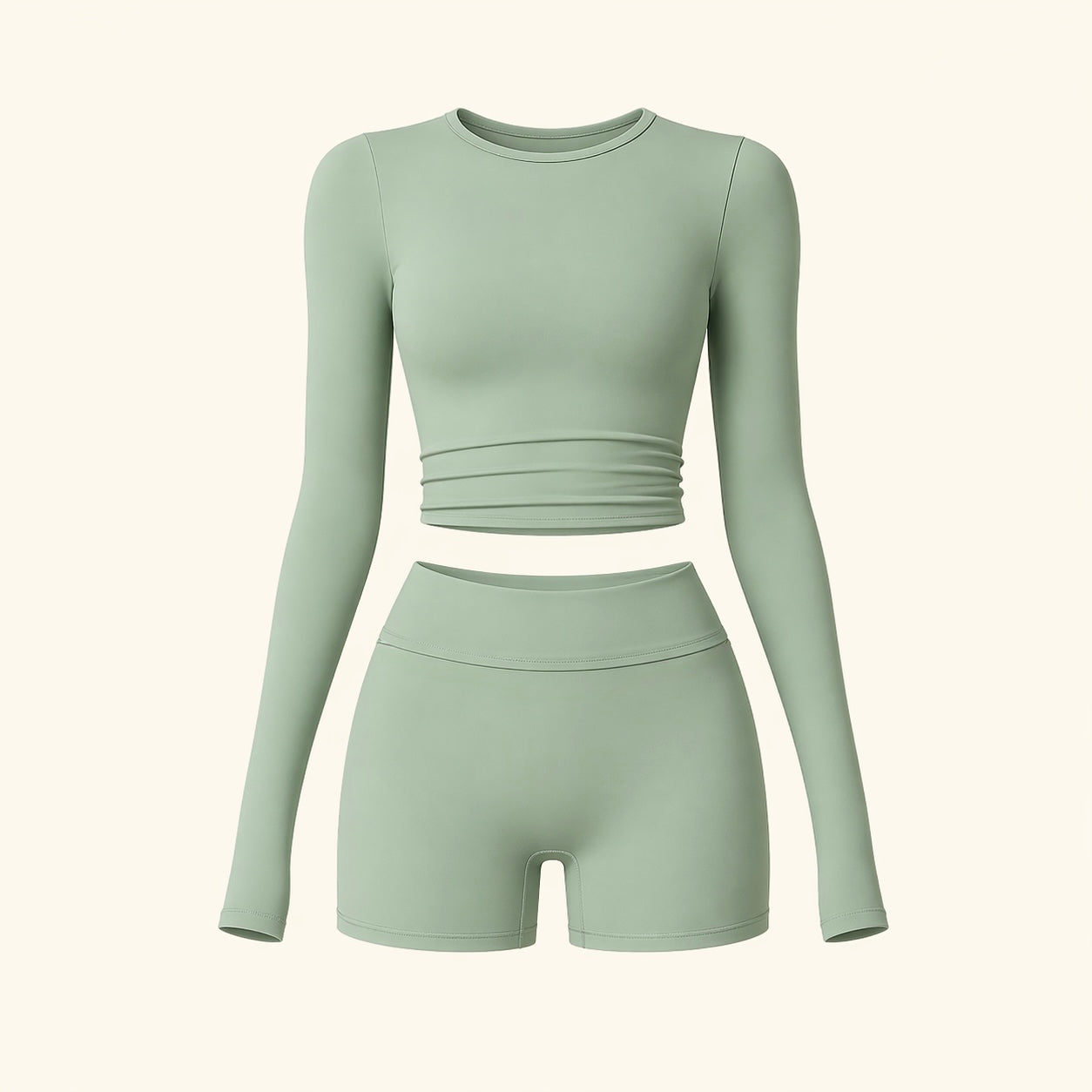 Sage activewear set flat lay: long-sleeve cropped top and high-waist biker shorts