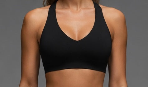 Black sports bra with V-neck, racerback straps, studio front view