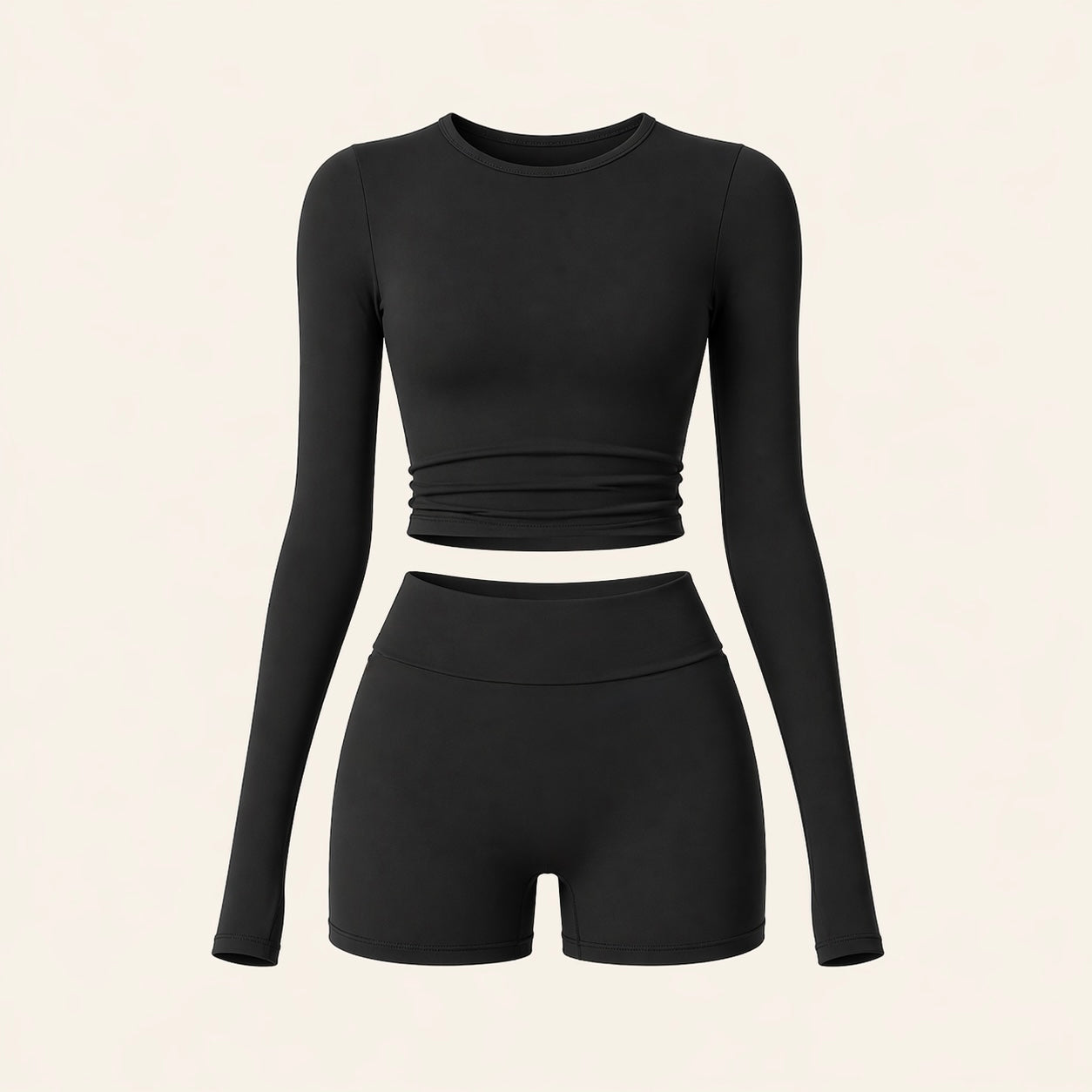 Black activewear set flat lay: long-sleeve cropped top and high-waist biker shorts
