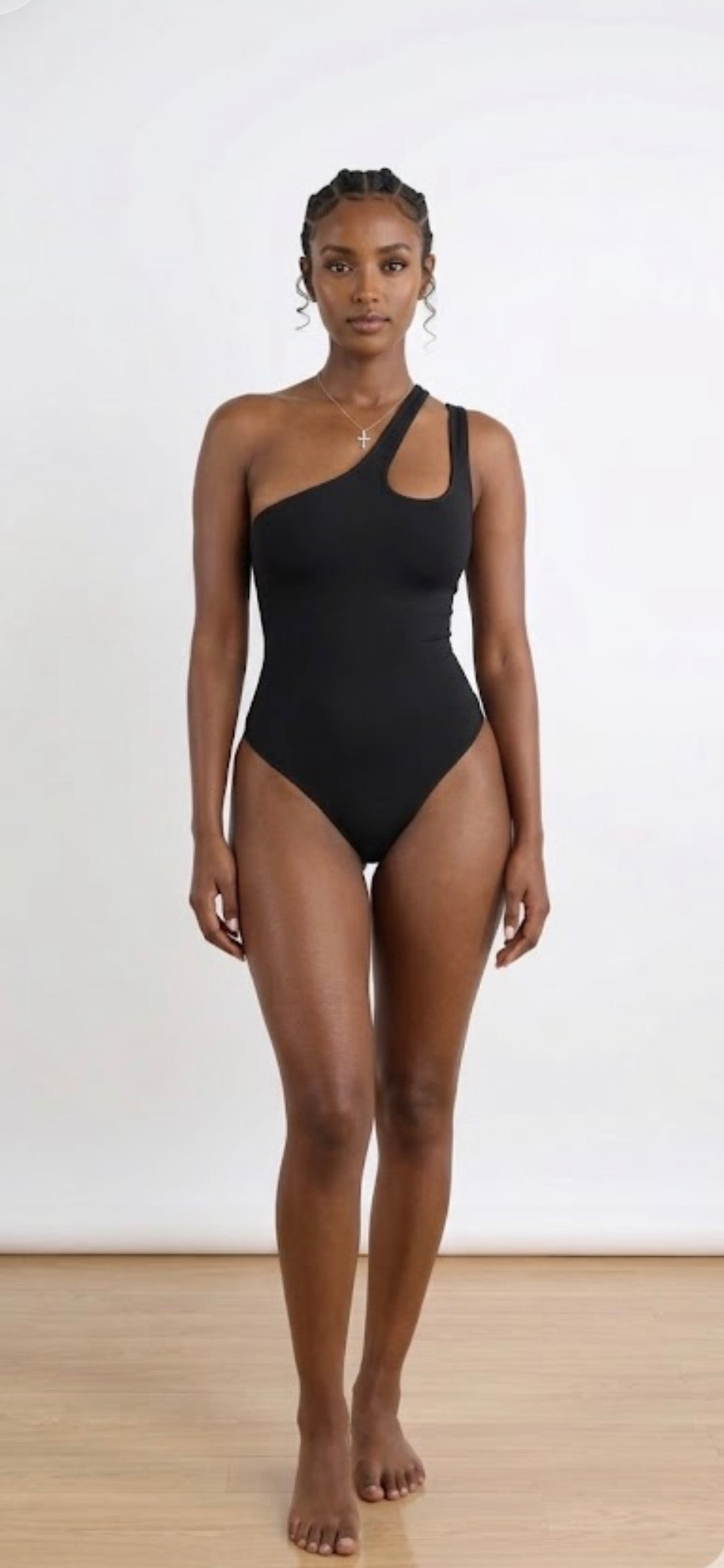 Asymmetrical one-shoulder sculpting bodysuit in black, with side cutout.