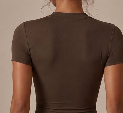Brown fitted romper back view with short sleeves and high neckline
