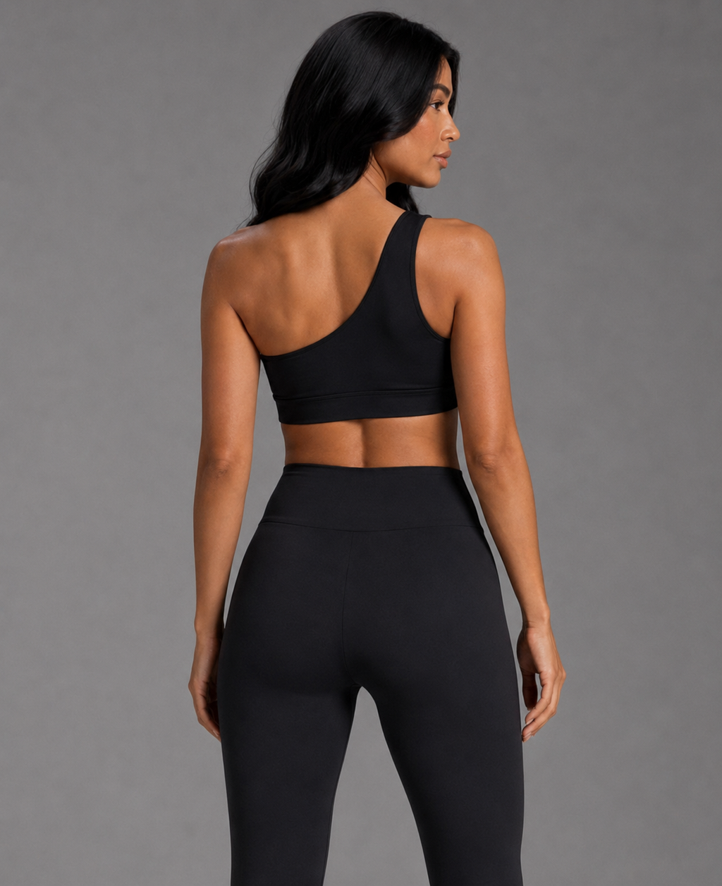 Black asymmetrical sports top with one-shoulder neckline, racer back detail