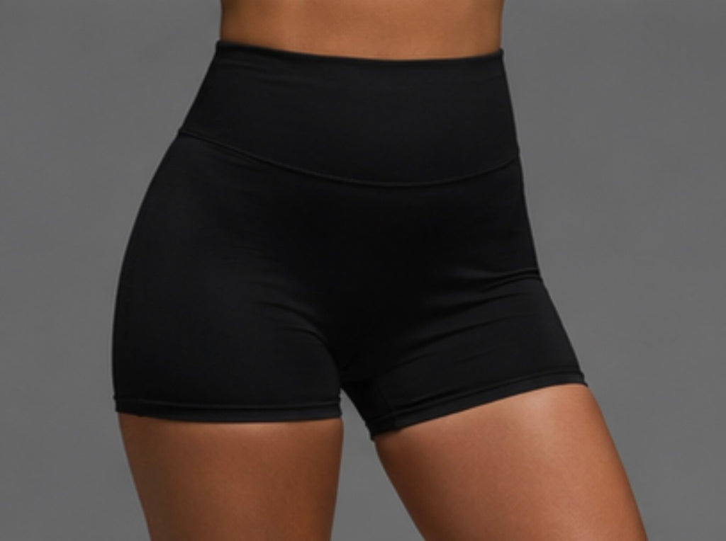 Black high-waist athletic shorts, contoured side seam close-up