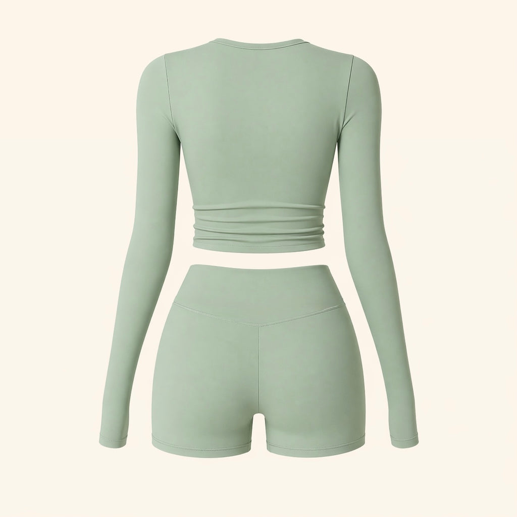 Sage activewear set flat lay: back view of long-sleeve cropped top and biker shorts