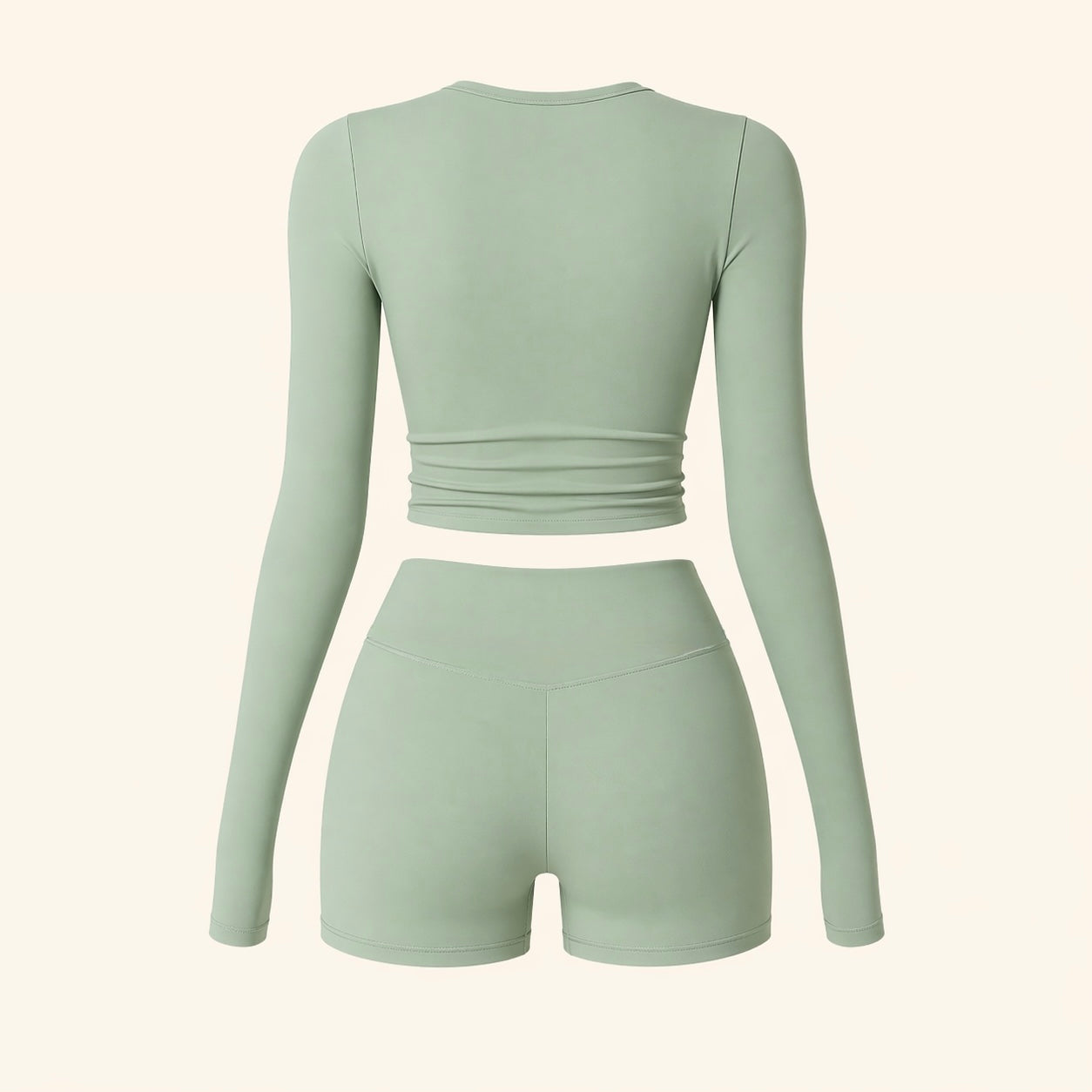 Sage activewear set flat lay: back view of long-sleeve cropped top and biker shorts