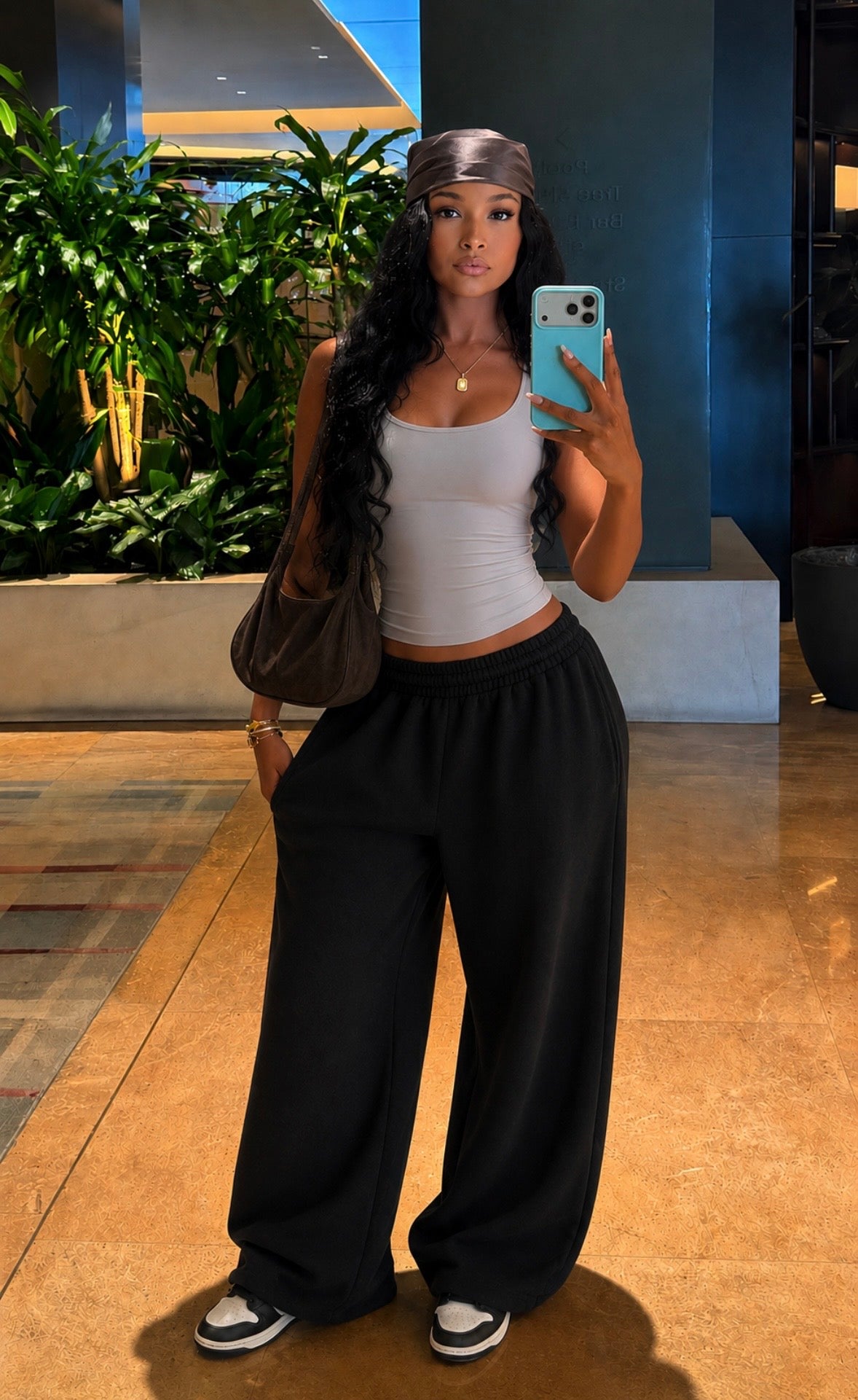 Oversized black sweatpants with wide legs and elastic waist