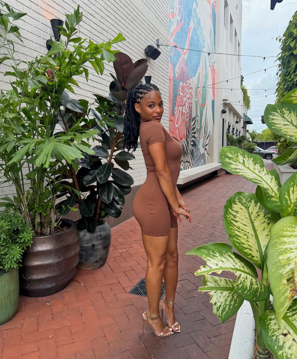 Brown sculpting romper with short sleeves and tapered fit
