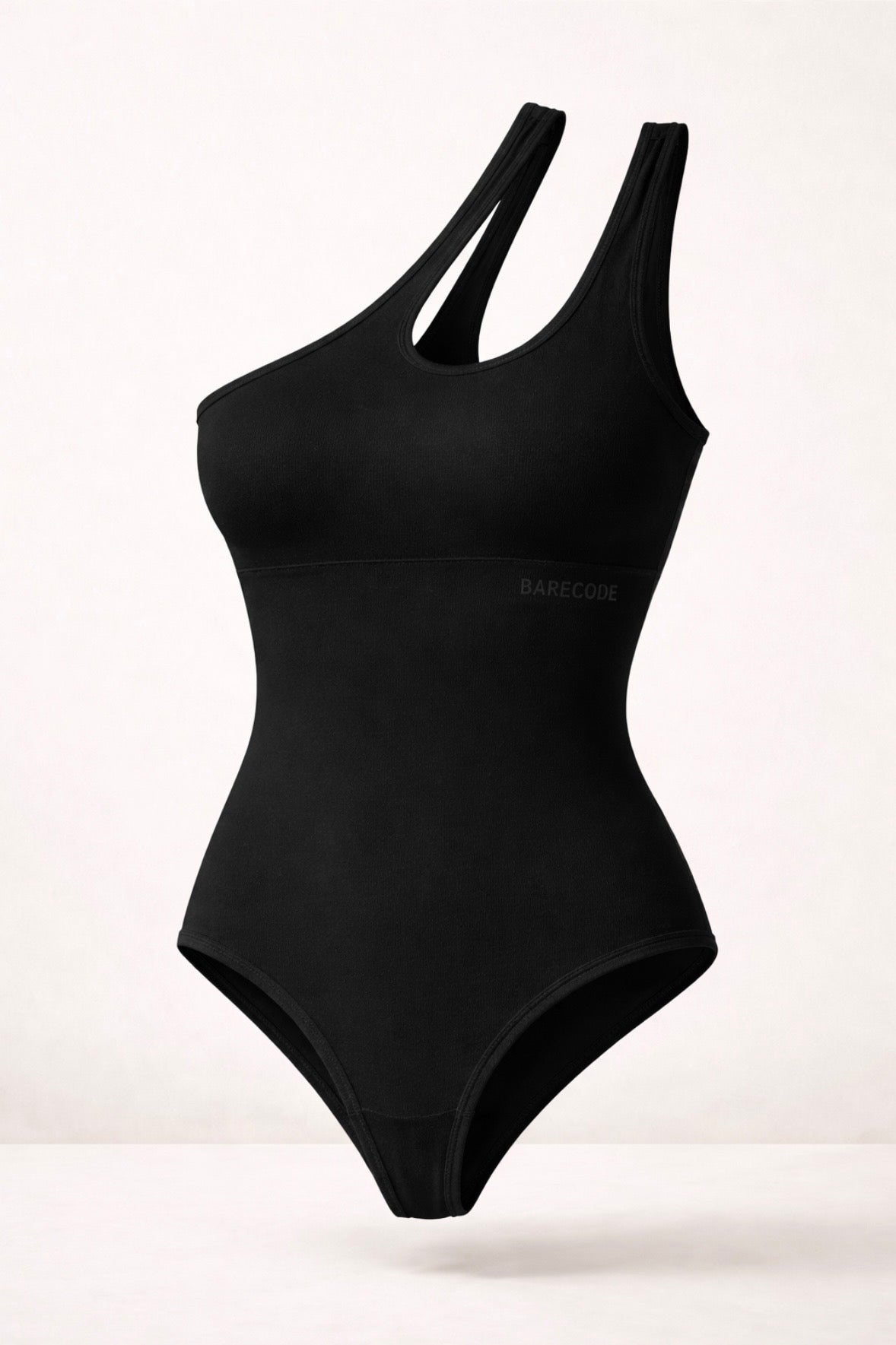 Asymmetrical one-shoulder sculpting bodysuit in black, with side cutout.