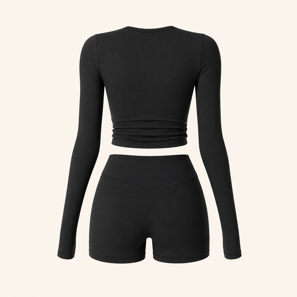 Black performance activewear set with long-sleeve cropped top and high-waist shorts (back view).