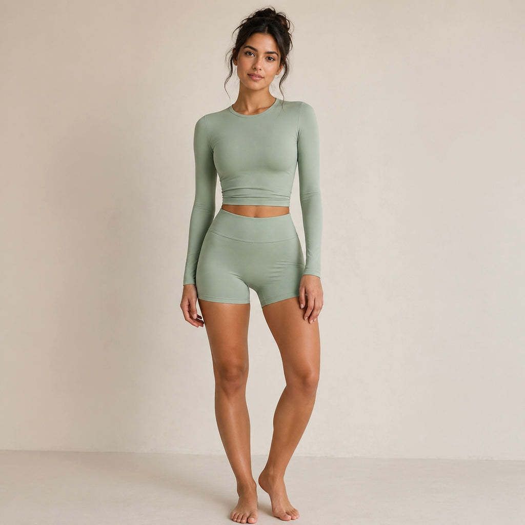 Sage activewear set with long-sleeve cropped top and high-waist biker shorts