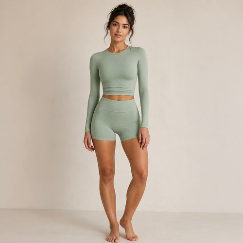 Sage activewear set with long-sleeve cropped top and high-waist biker shorts