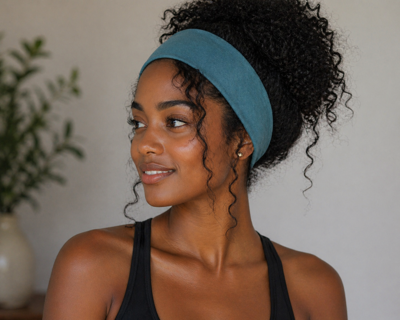Wide polyester headband in turquoise worn on model