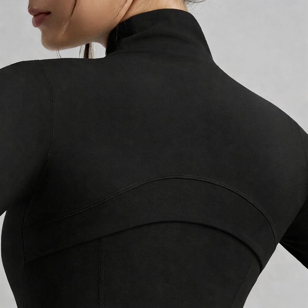 Black zip-up sculpting jacket close-up of back seam and high collar