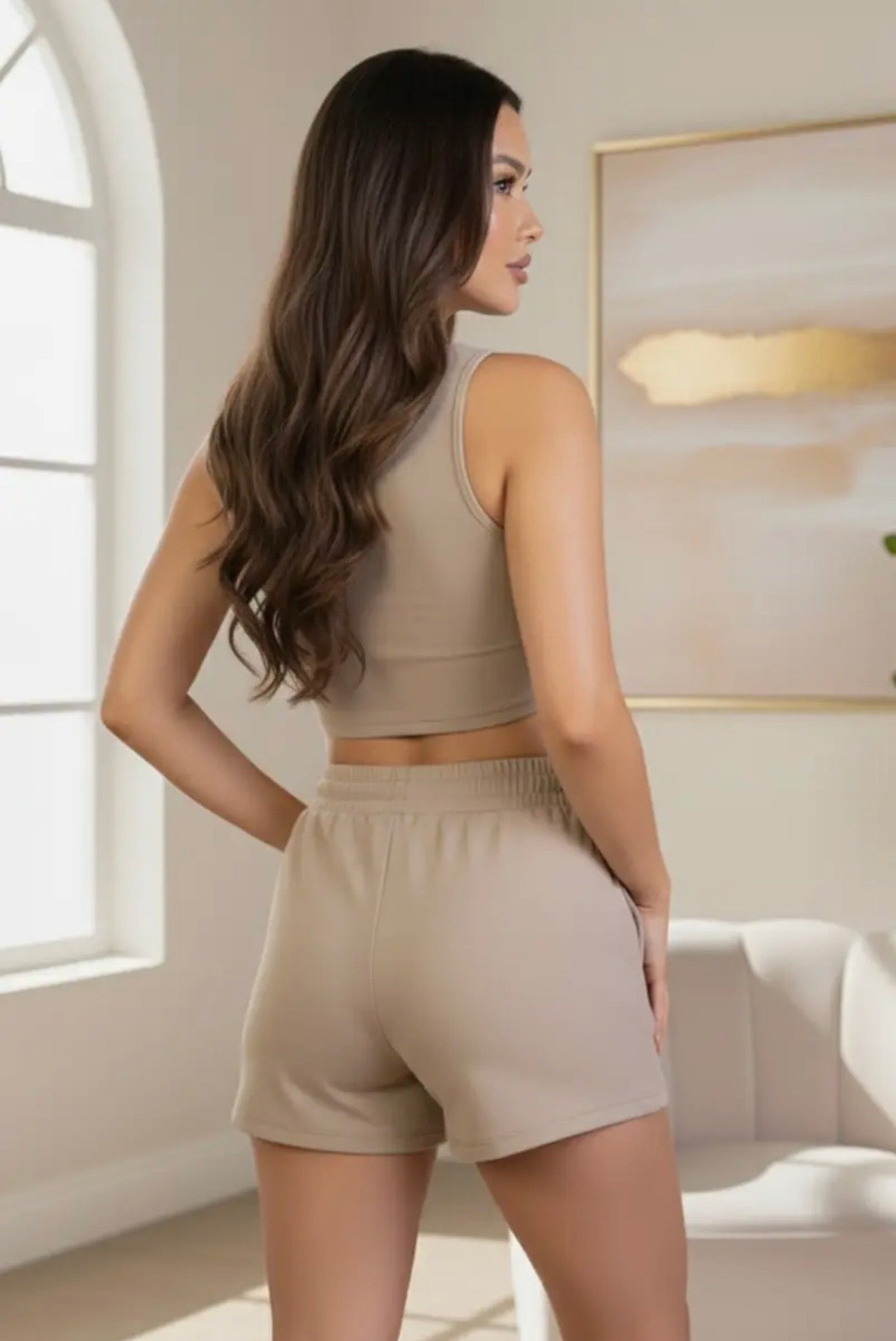 Beige loungewear two-piece set with racerback crop top and drawstring shorts on model